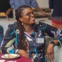 faculty smiling at table